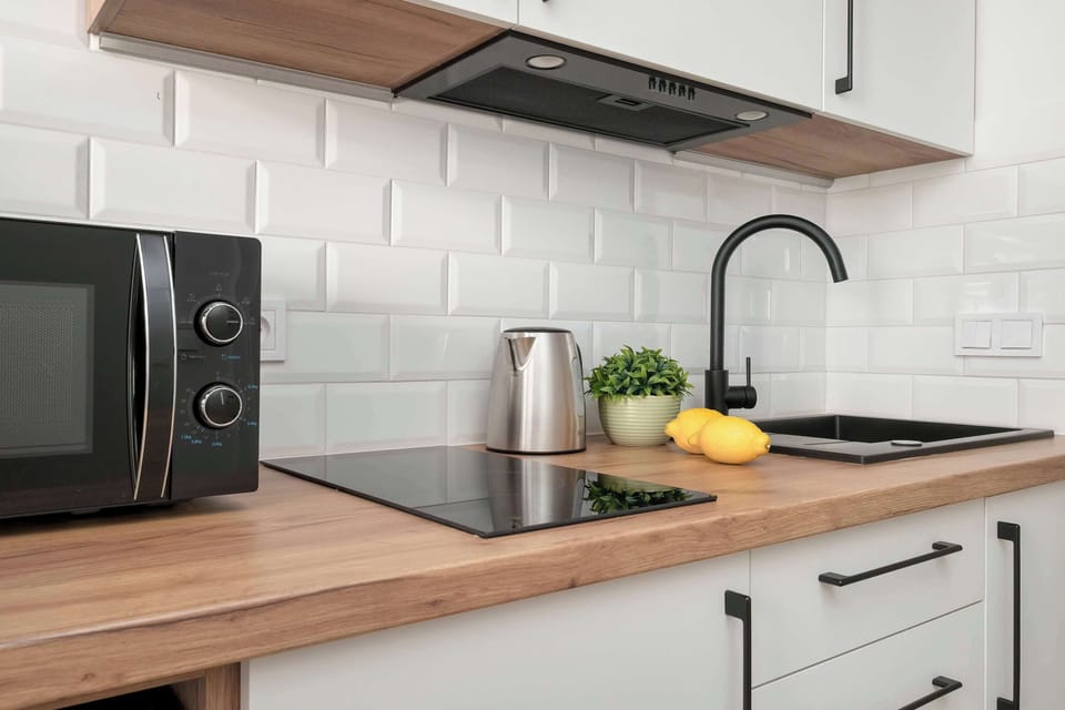 The sleek design of the kitchenette blending seamlessly with the living area.