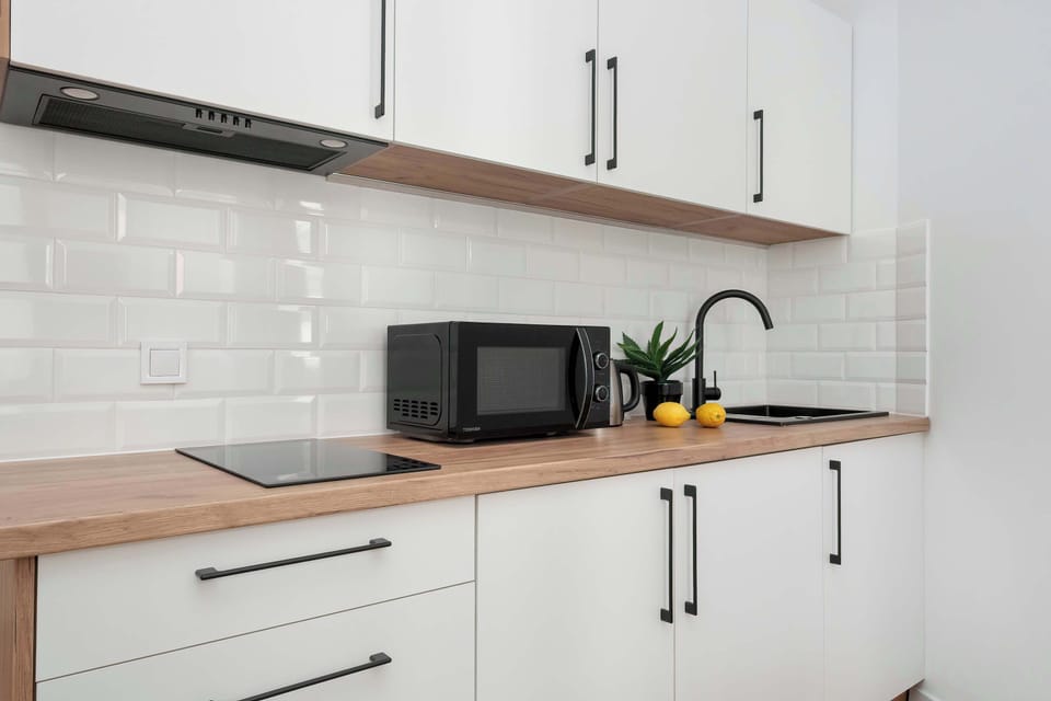 The sleek design of the kitchenette blending seamlessly with the living area.