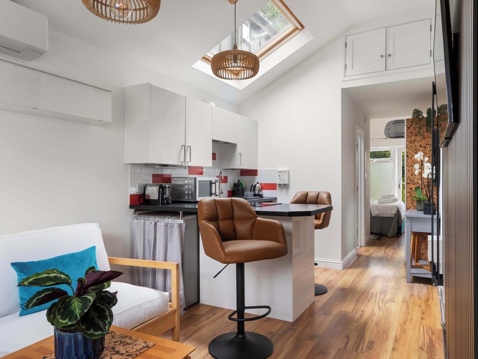 The annexe features a modern open-plan layout designed to provide both comfort and convenience, creating a bright and practical space for guests to relax, dine and unwind during their stay.