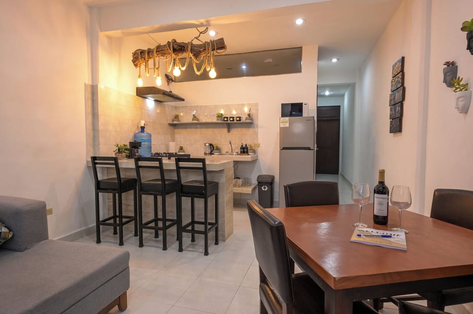 Warm modern kitchen and dining space with breakfast bar seating