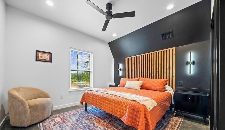 The first king bedroom features soft bedding, warm wood tones, and just the right amount of simplicity for a peaceful night's sleep.