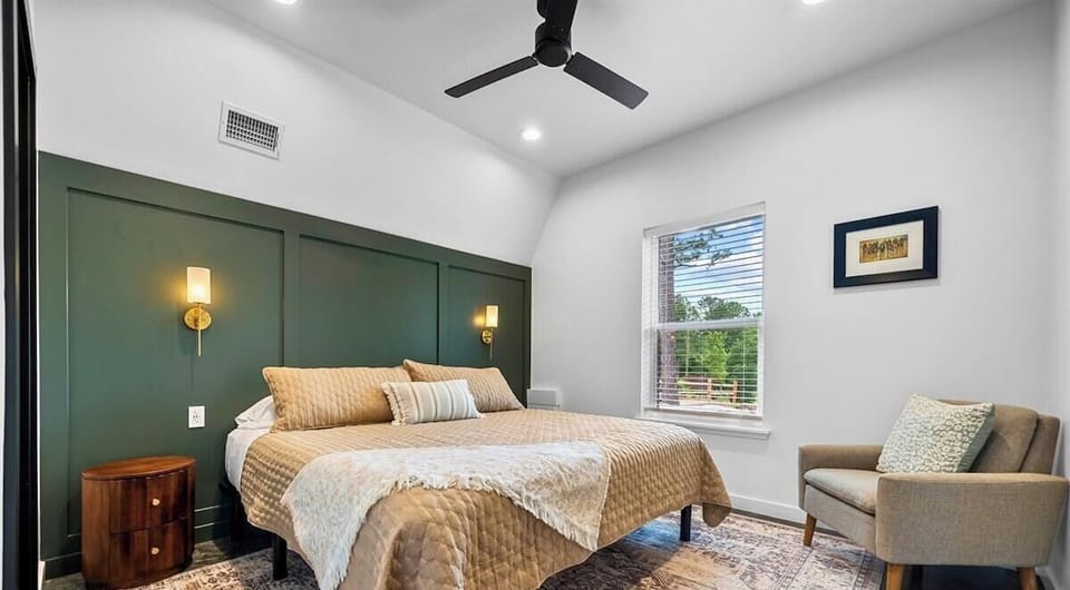 The second bedroom is bright and inviting with an additional king bed with neutral tones and plush bedding.