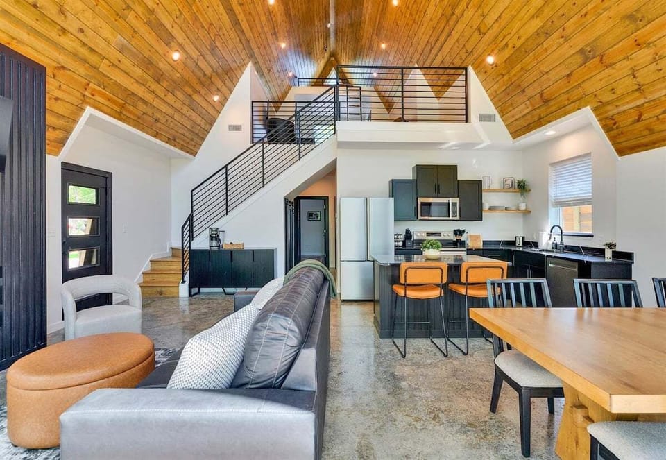 Vaulted ceilings and cozy furniture fill the main living area with warmth and light, creating a space where everyone can gather and feel right at home.