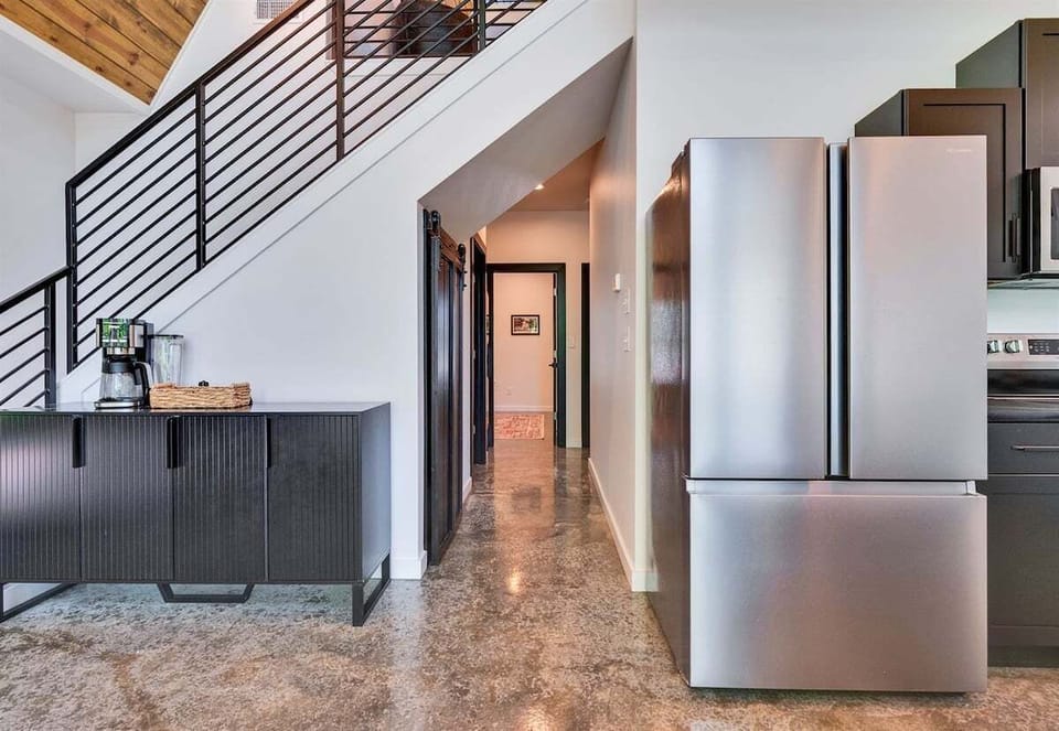 Clean lines, soft lighting, and a natural flow give this hallway a bright, inviting feel as it leads you from one space to the next.