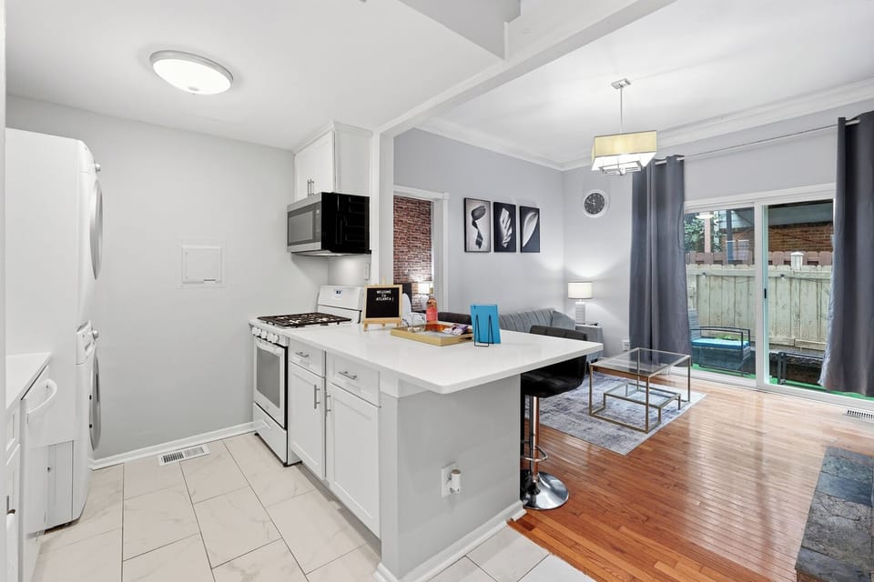Bright open-concept kitchen and living area with patio access