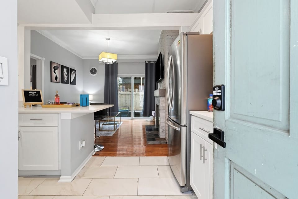 Bright open-concept entry, kitchen, and living space with modern finishes