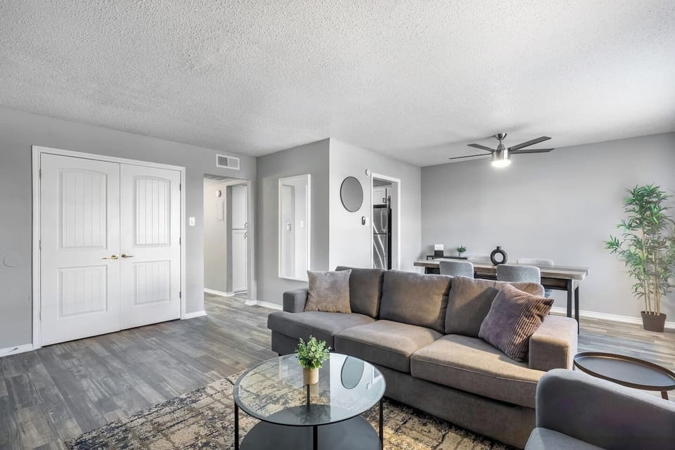 Spacious and inviting living area with comfortable seating and a smart TV, perfect for relaxing after exploring Arlington or attending events at AT&T Stadium.