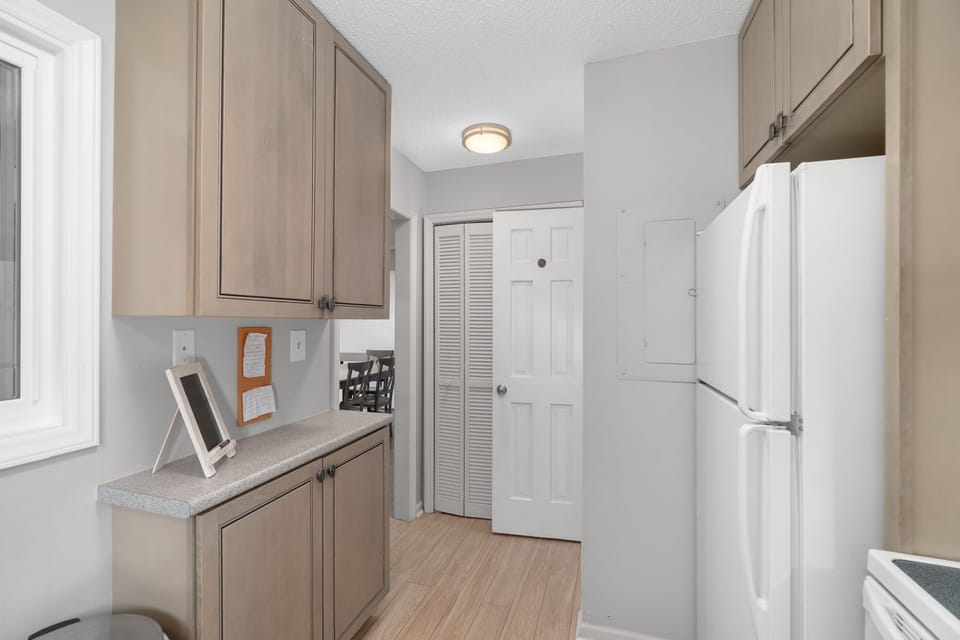 Well-designed kitchen layout featuring convenient access to the pantry and powder room, making everyday living simple and efficient. A comfortable, fully equipped space for your beach stay in Pine Knoll Shores on Bogue Banks.