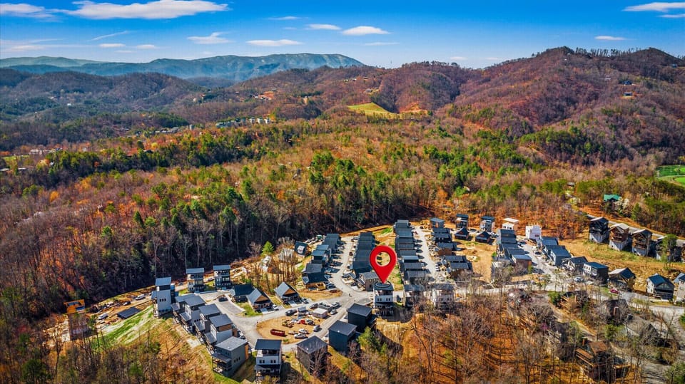 Find your rooftop from the air, tucked into the ridge above the cabin street. It is the highest seat on the block and you have it to yourselves.