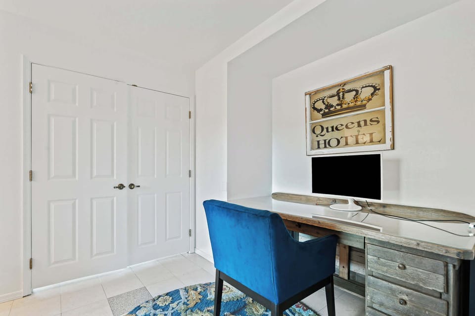 Dedicated workspace with a desk, comfortable chair, and monitor, ideal for remote work or planning your day.