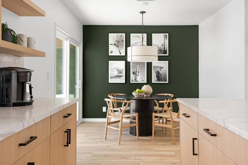Share group meals at the round dining table for four, highlighted by a gorgeous green accent wall, modern lighting, and a handy Keurig coffee station.