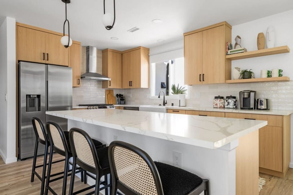 Modern kitchen with warm wood cabinetry, a spacious island, and sleek finishes for effortless entertaining.
