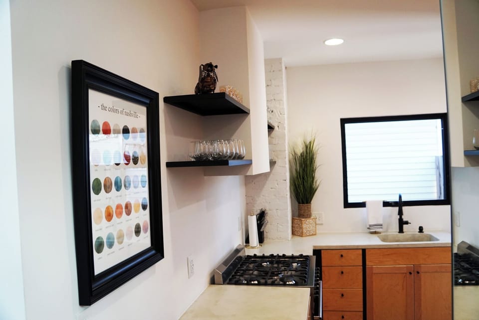 Bright, modern kitchen with gas range, open shelves and sunny window