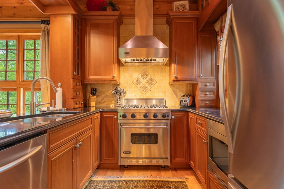 With spacious countertops, quality appliances, and an open layout, the kitchen is designed to make cooking and gathering easy during your mountain getaway.