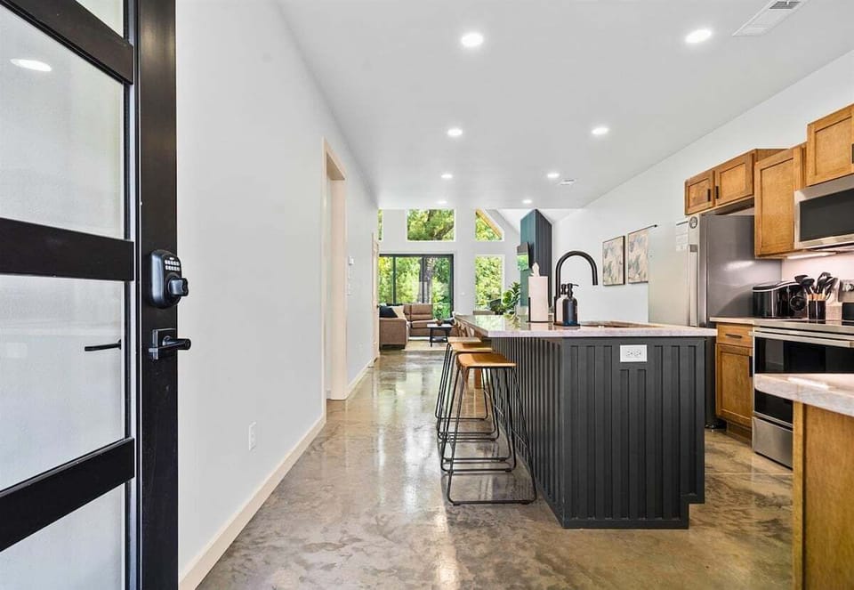 Sleek kitchen entrance with polished floors and natural light throughout.