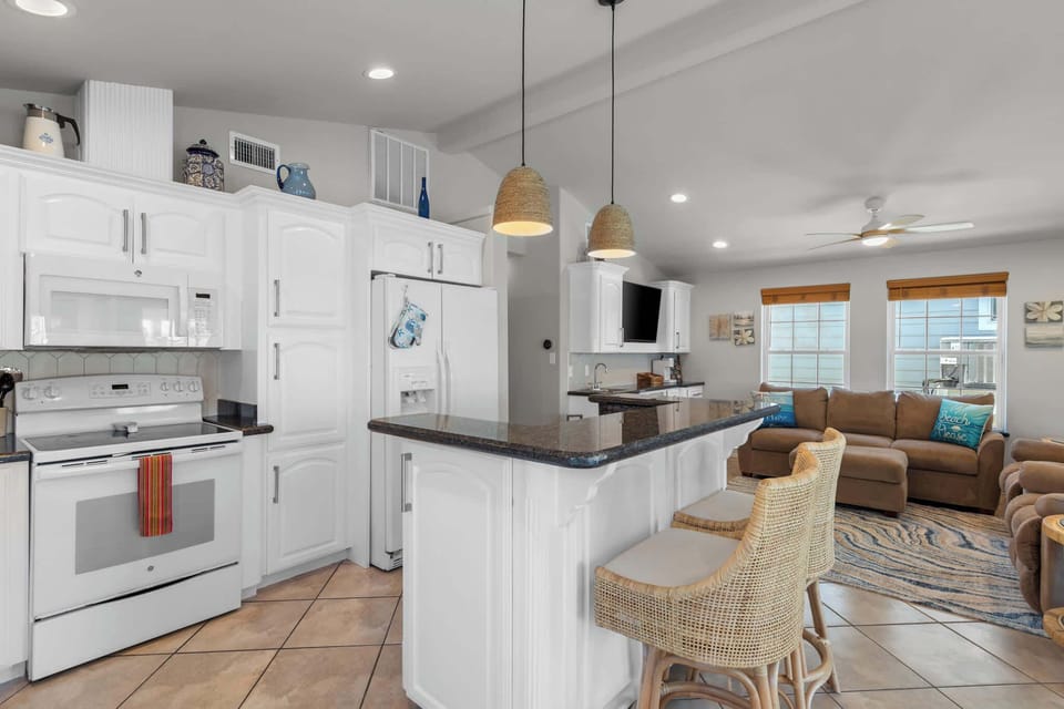 The kitchen opens to the living and dining areas