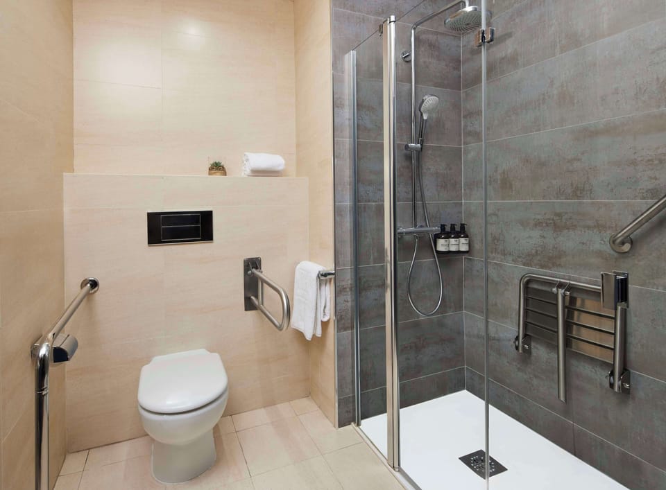 Bathtub, eco-friendly toiletries, hair dryer, towels