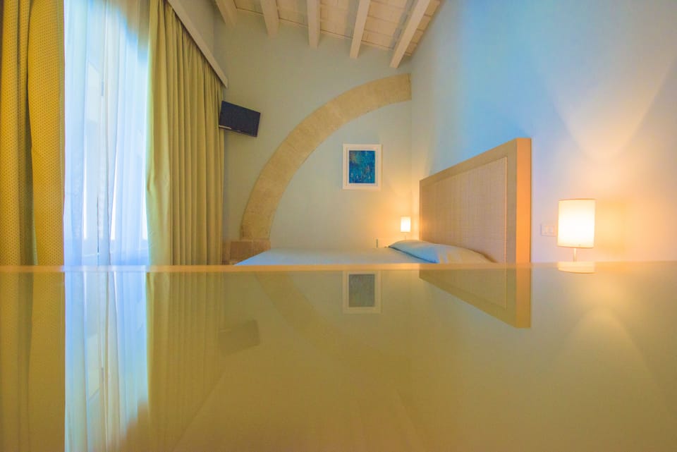 Exclusive Suite, 1 Bedroom, Partial Sea View, Ground Floor | 1 bedroom, down comforters, minibar, in-room safe