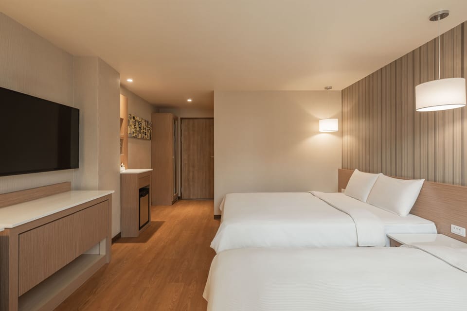 Business Quadruple Room | Living area | 42-inch LCD TV with cable channels, TV