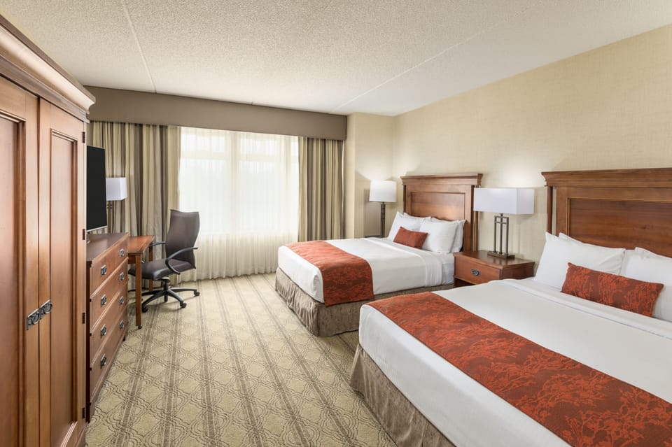 Hypo-allergenic bedding, desk, laptop workspace, blackout drapes