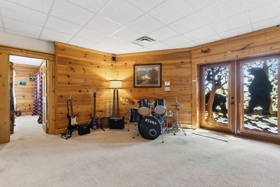 A unique creative space featuring a drum set and guitars for the musically inclined.
