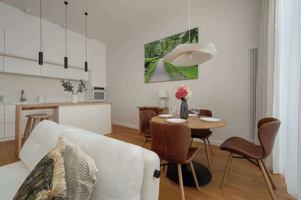 A dining and living space view highlighting the connection between kitchen and seating area. The design feels cohesive, modern, and practical.