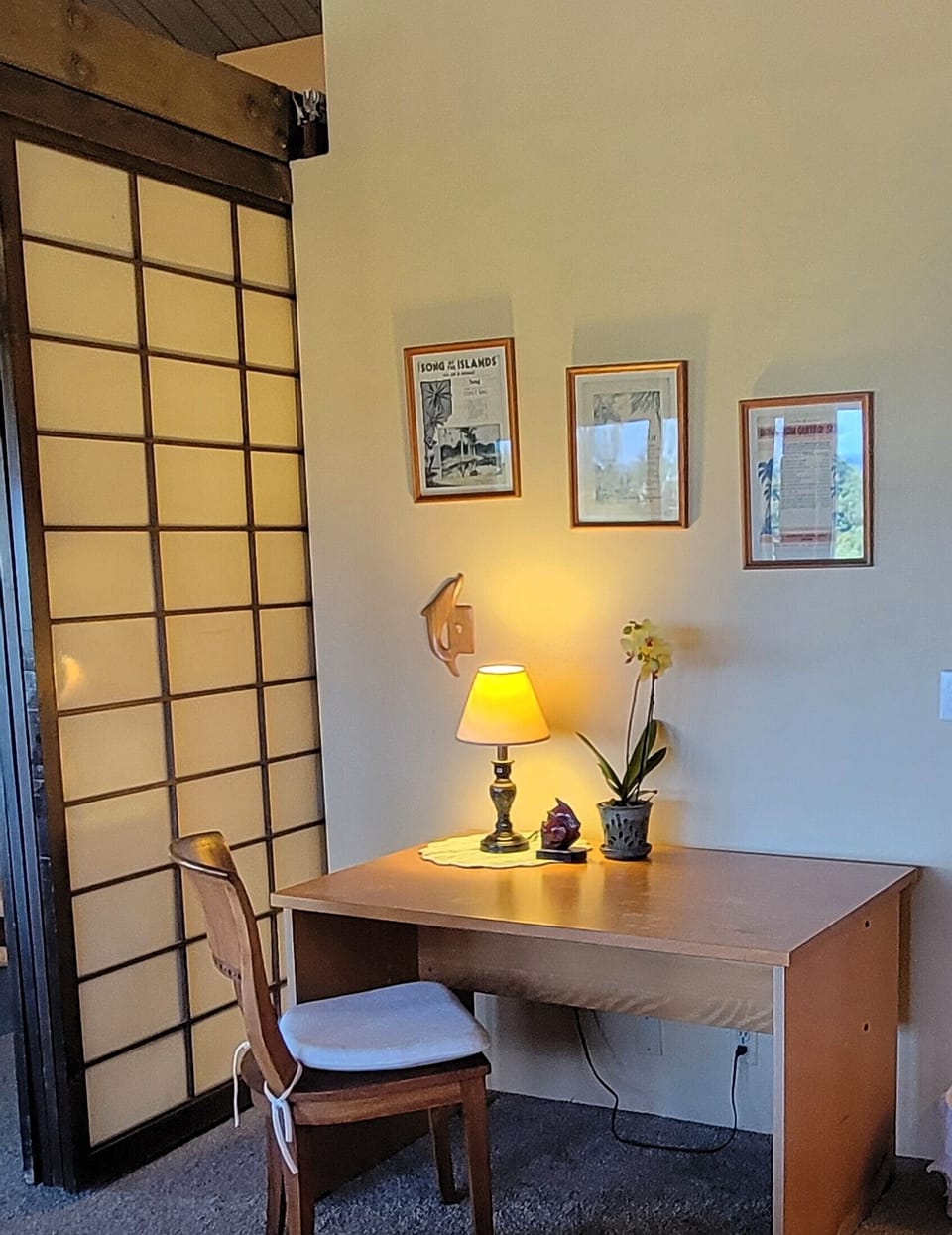 Dedicated desk with a lamp and chair adjacent to the great room and guest room.