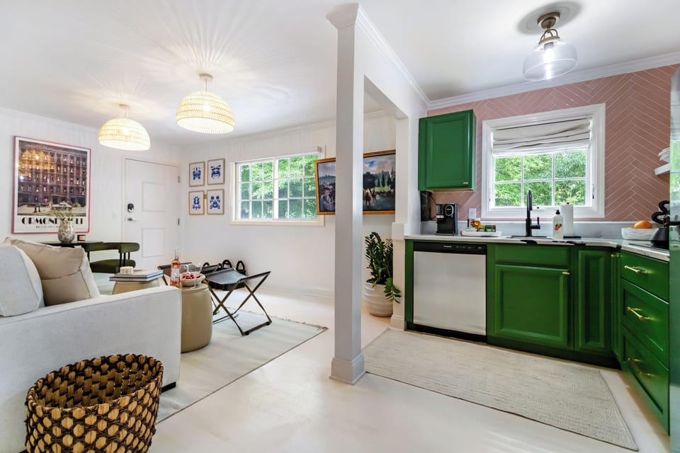 The kitchen seamlessly flows into the dining and living spaces, creating an open and inviting layout perfect for relaxing, entertaining, and staying connected throughout your stay.