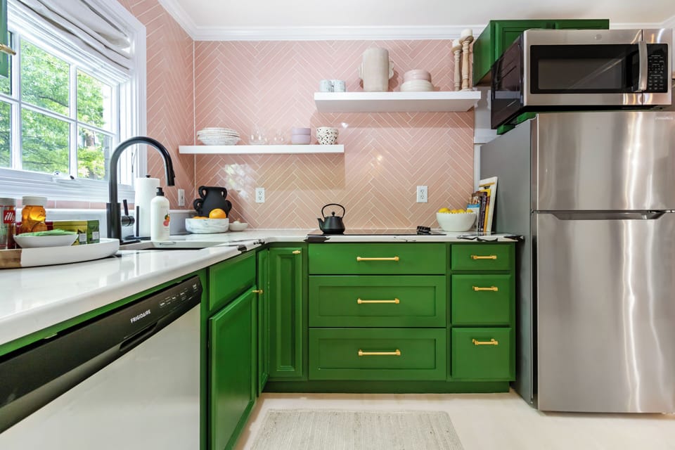 This beautifully designed kitchen offers sleek finishes, a cozy dining setup, and a nearby full-body mirror that adds both convenience and a luxury touch.