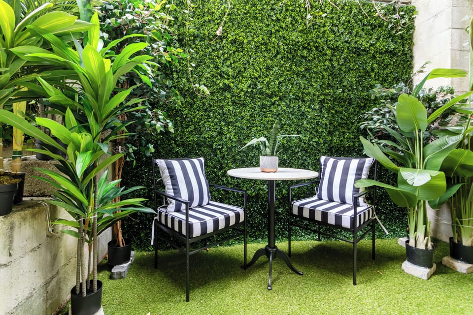 Enjoy a peaceful outdoor seating area surrounded by lush greenery — the perfect hidden spot for morning coffee, evening wine, or a quiet moment to unwind.