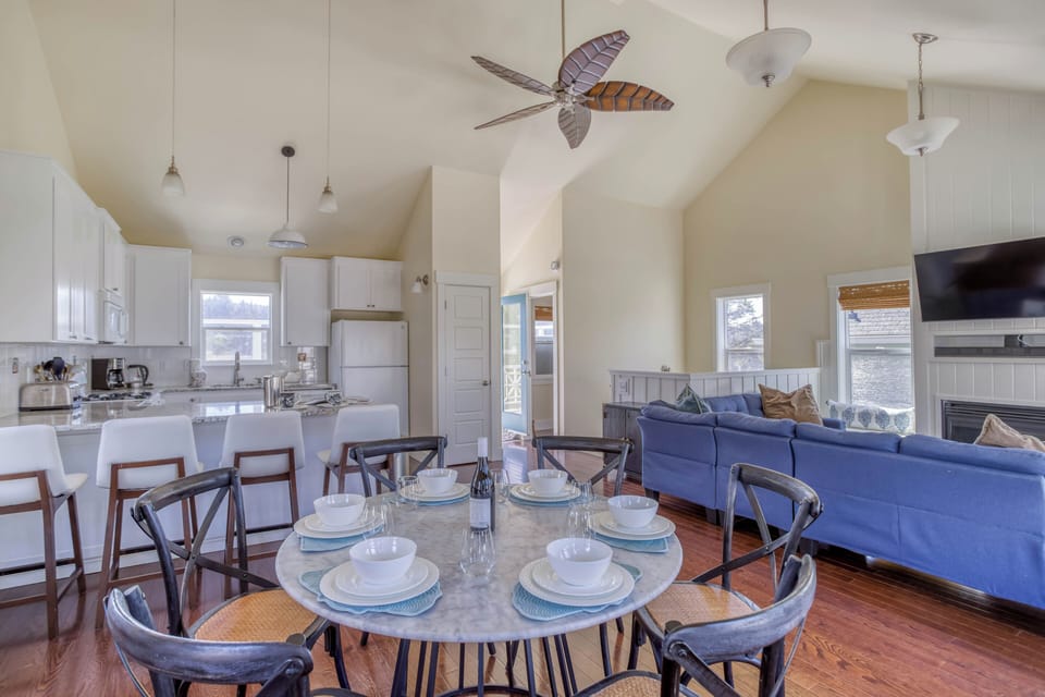 Gather around the dining table and enjoy meals together in this bright, open living space designed for comfort and connection.