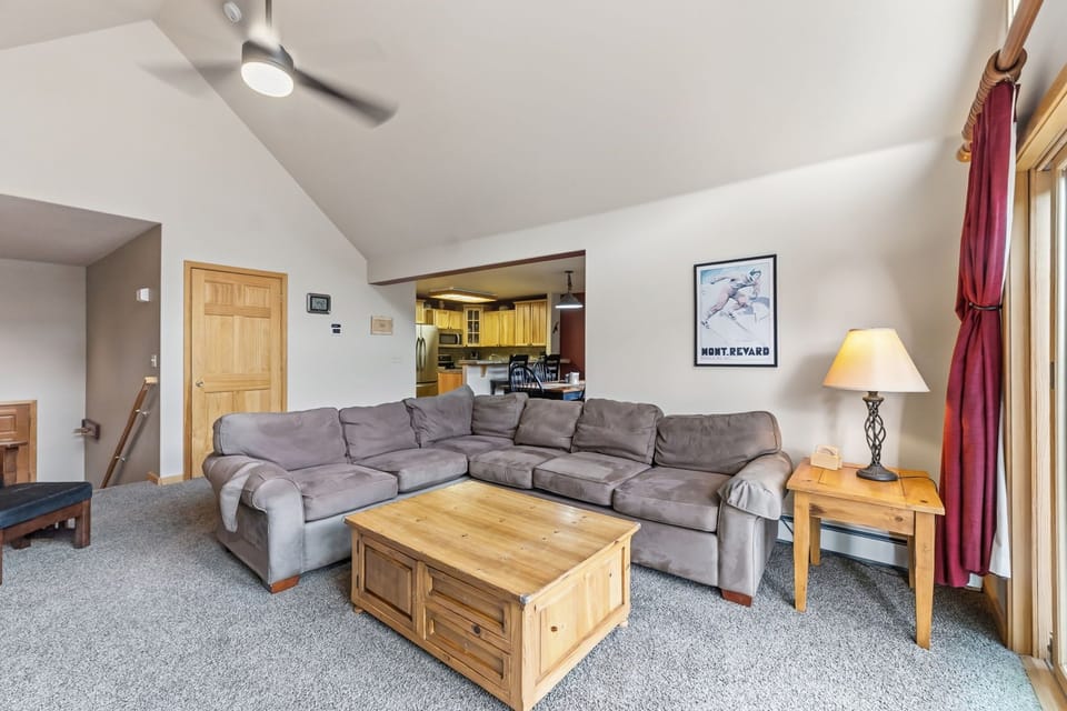 Sink into your cozy sectional sofa while enjoying mountain views and open kitchen access in this inviting living space.