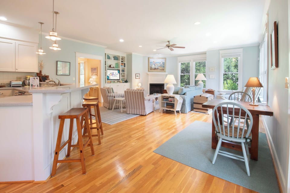 Settle into your serene open-concept retreat where soft coastal hues and natural light create a peaceful haven. Picture yourself unwinding by the fireplace or sharing stories around the inviting living spaces designed for togetherness.