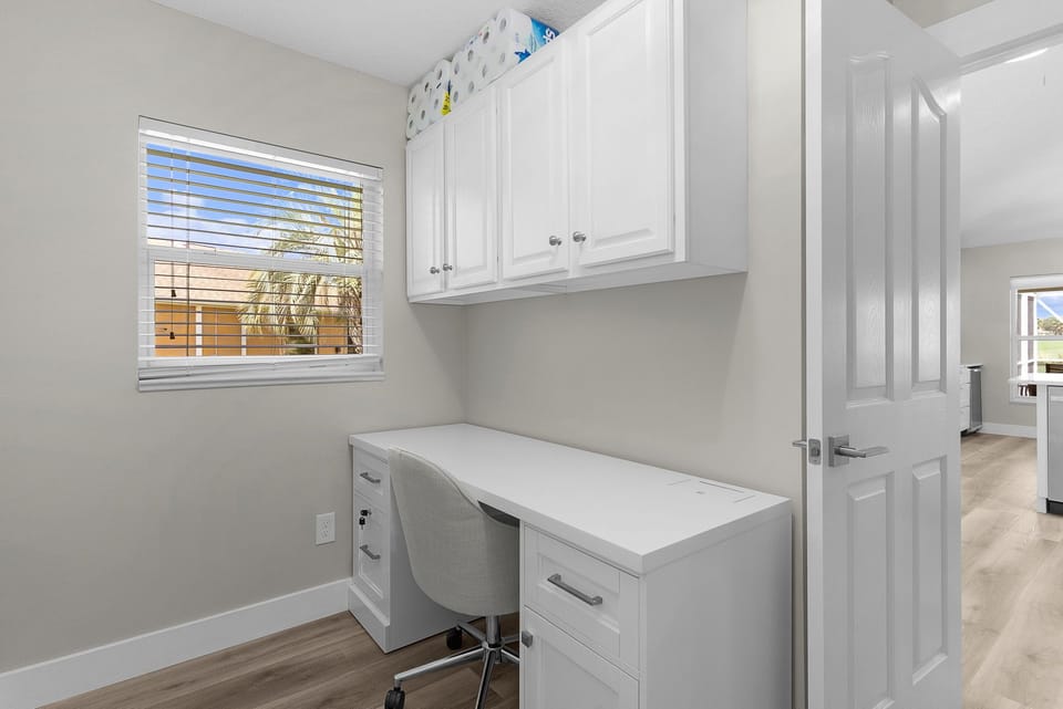 A bright, dedicated workspace with a clean desk and plenty of storage for staying organized during your stay. Sunlight filters through the window, creating a peaceful spot for planning your adventures or catching up remotely.