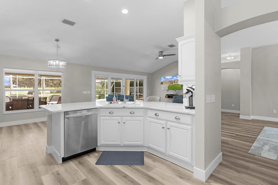 Your bright, open kitchen flows seamlessly into an airy living space, with windows framing lush backyard views and inviting you to cook, relax, and gather.