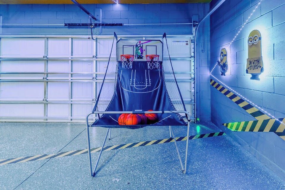 Experience a lively atmosphere in this unique recreational area, complete with a vibrant basketball game that encourages friendly competition. The cool blue tones and playful wall art create a fun environment for all ages.