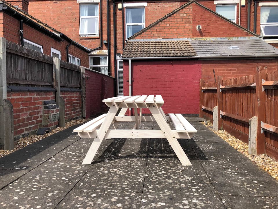 Outdoor Patio: Dine al fresco at this charming picnic table, perfect for sunny gatherings!