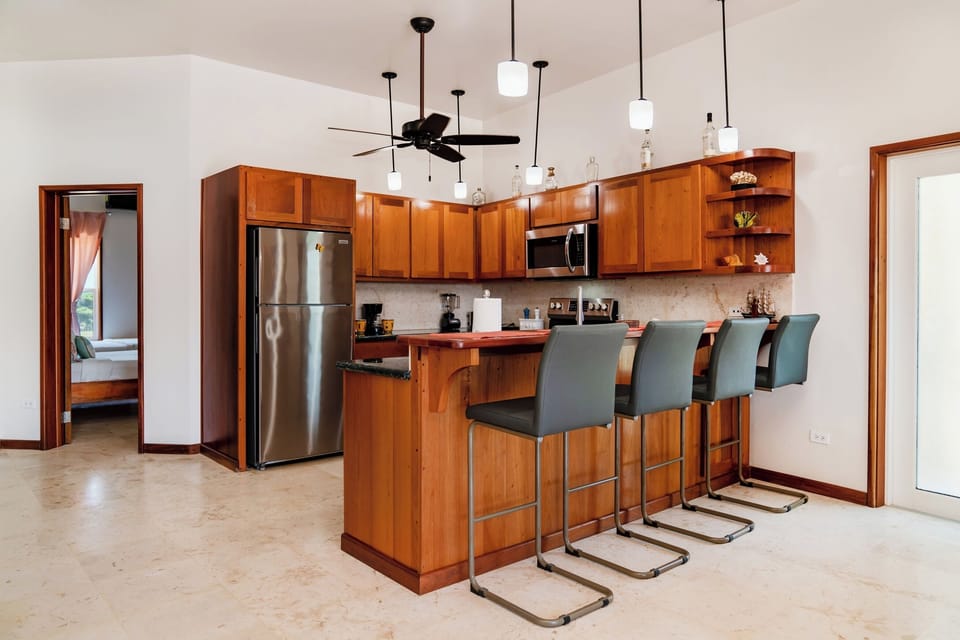Your fully equipped kitchen awaits with modern appliances and a welcoming breakfast bar—perfect for cooking together and gathering over morning coffee.