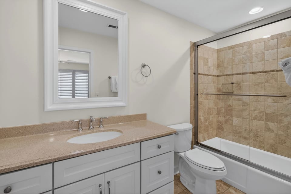 Step into your bright, spotless bathroom with classic tile accents and a sleek glass shower-tub. Everything you need for a refreshing start or relaxing end to your day.