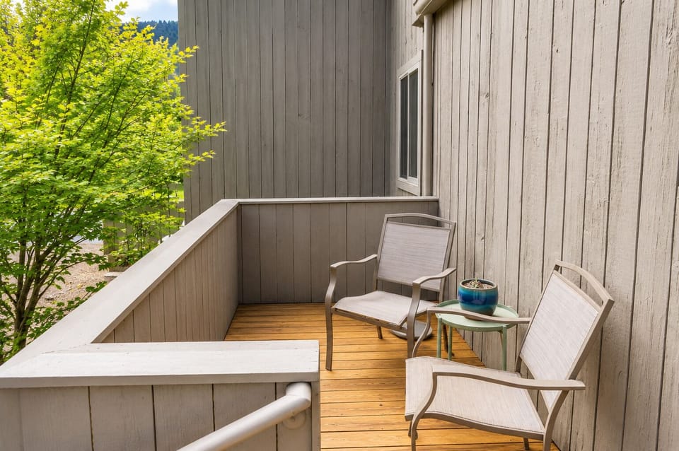 Unwind on your private balcony with morning coffee, fresh air, and peaceful tree-lined views that make every moment feel like a true escape.