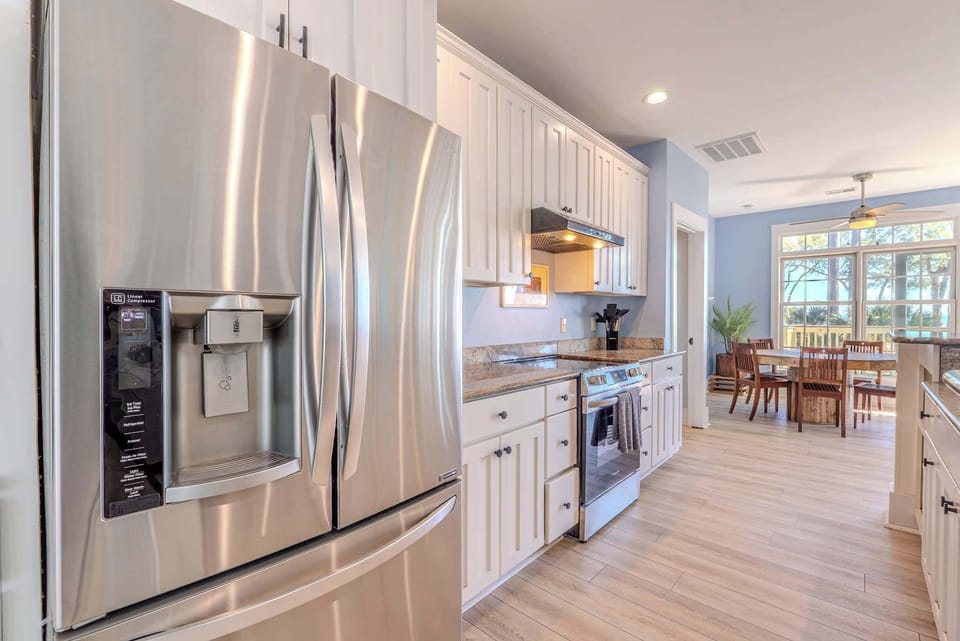 Stainless LG appliances, granite counters & crisp white cabinetry set the stage for effortless coastal living at 152 Ave of Oaks — where every detail is curated for the discerning guest on Hilton Head Island.