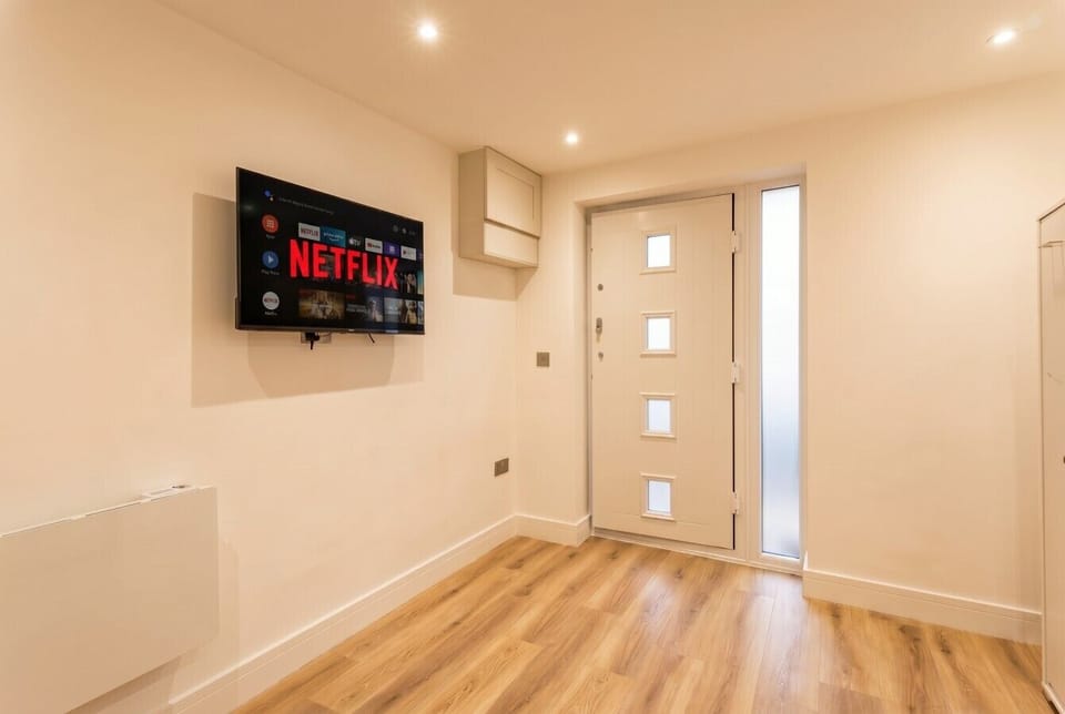 Cozy Netflix nights await on the wall-mounted smart TV.