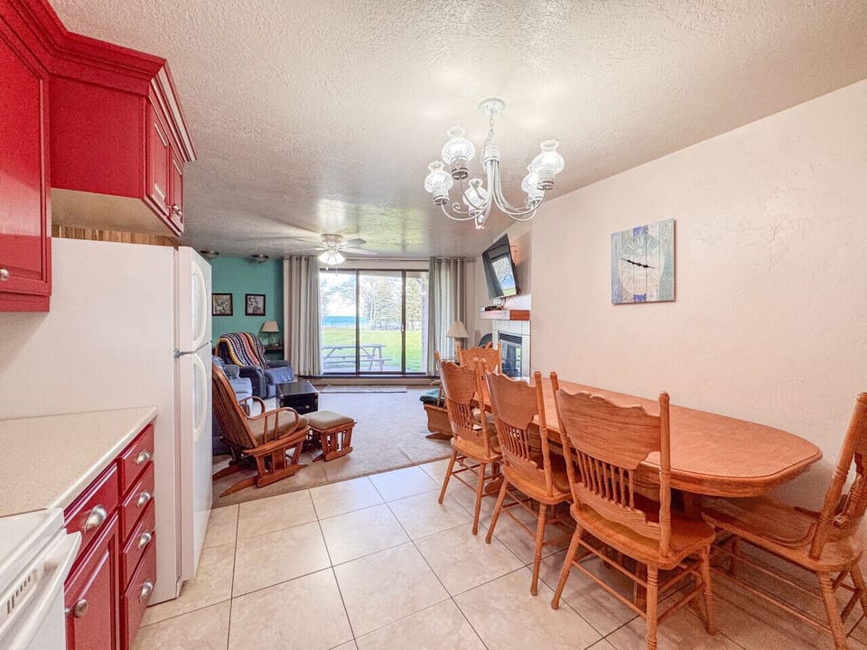 Warm dining space flows into cozy living area with relaxing patio views.