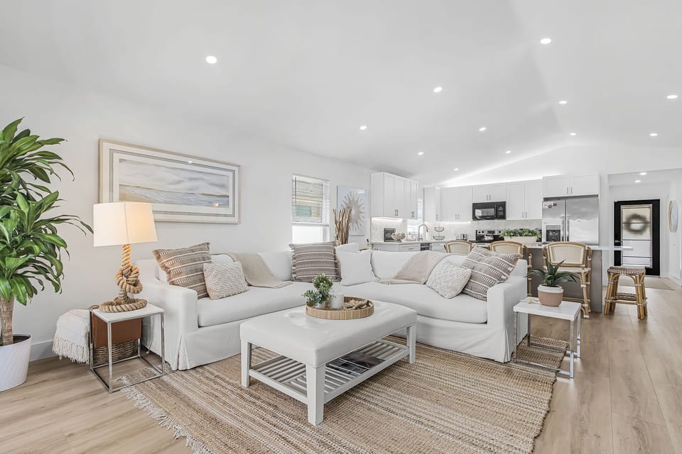 Bright open-concept living area with comfortable seating, a fully equipped kitchen, and plenty of space to relax together.