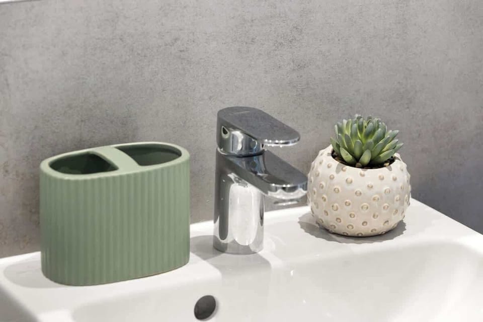 Close-up sink detail w/ modern faucet & clean countertop