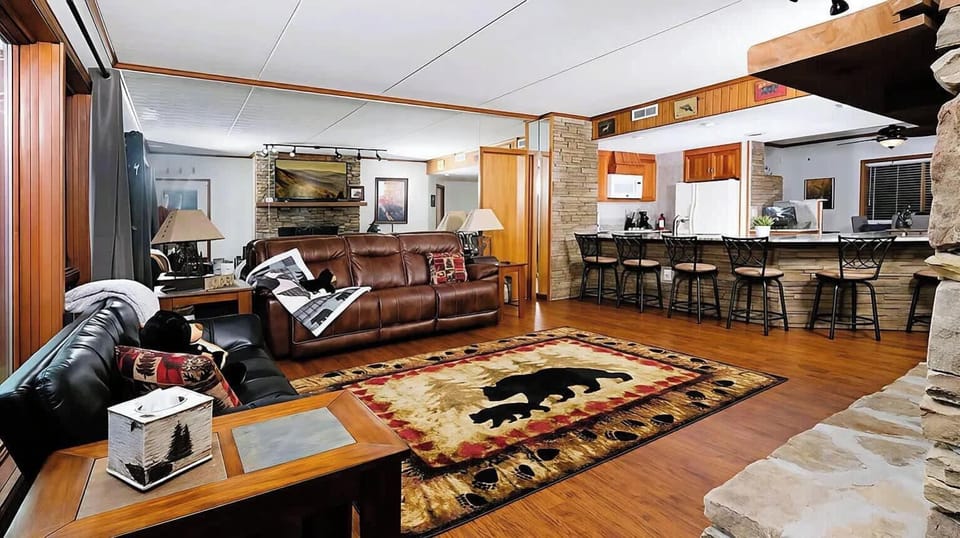 Cozy, open living room w/ smart TV, fireplace, and sun-porch access