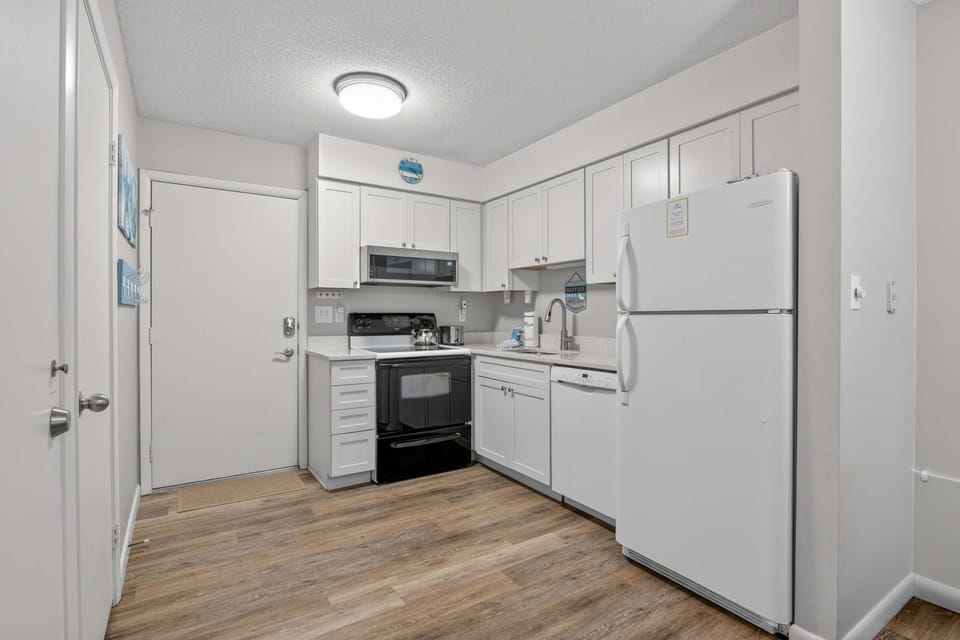 Modern white kitchen with appliances.
