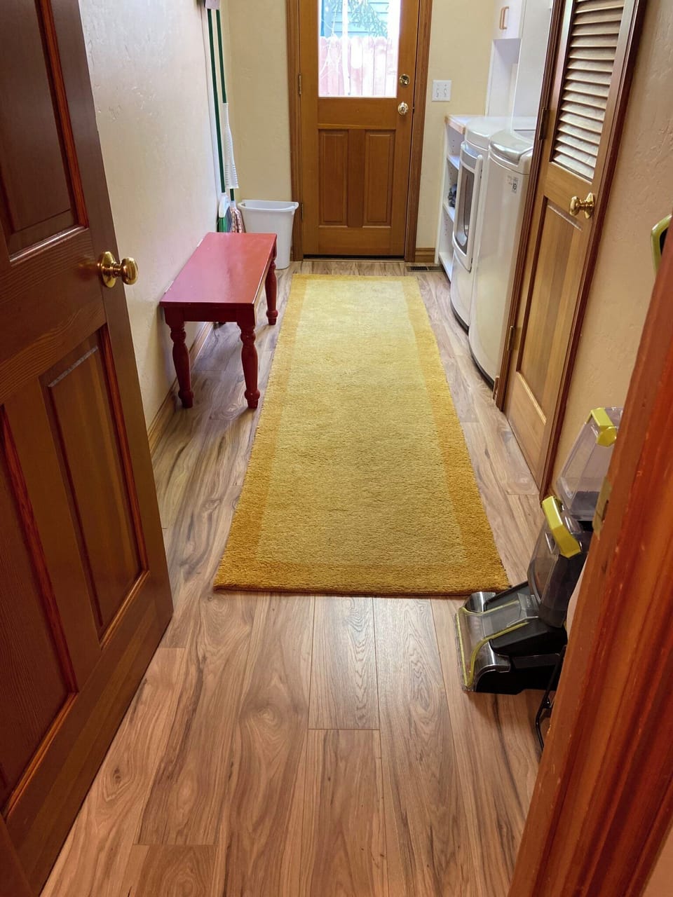 Spacious laundry room with plenty of hooks for coats and gear.
