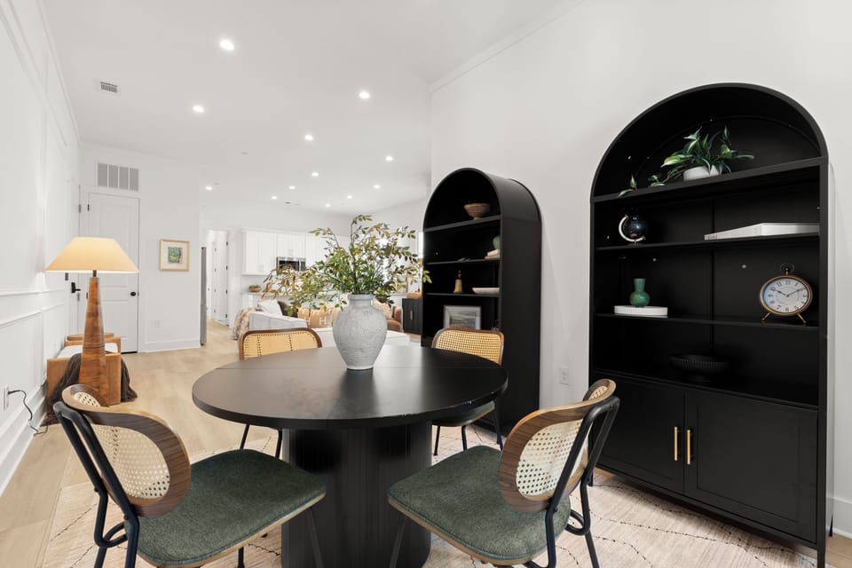 Elegant dining nook with designer shelving and bright open-concept flow