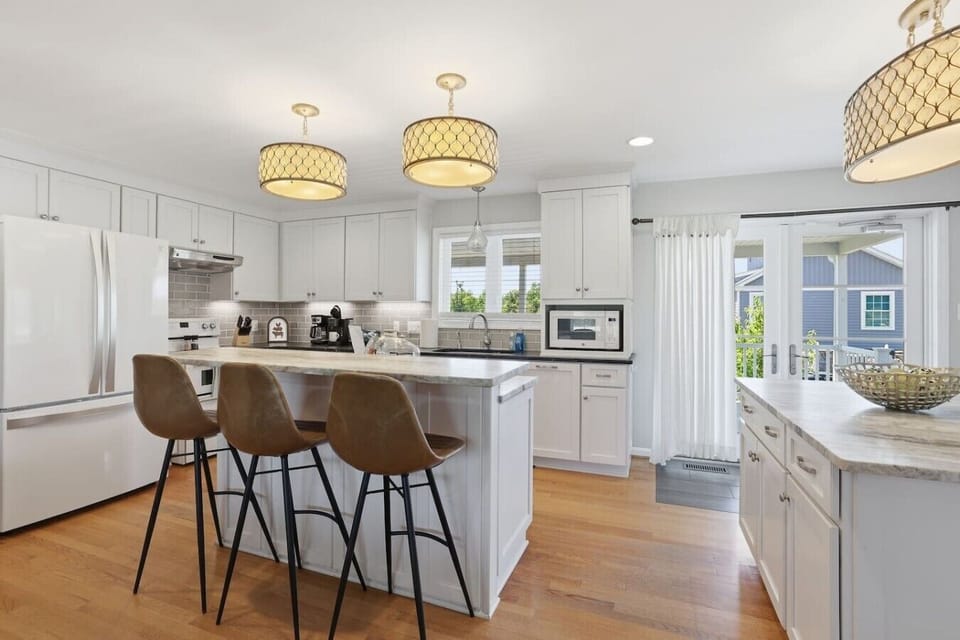 Modern, fully equipped kitchen with sleek finishes, island seating, extra bar space, and a dedicated coffee nook—bright, stylish, and perfect for effortless meals.